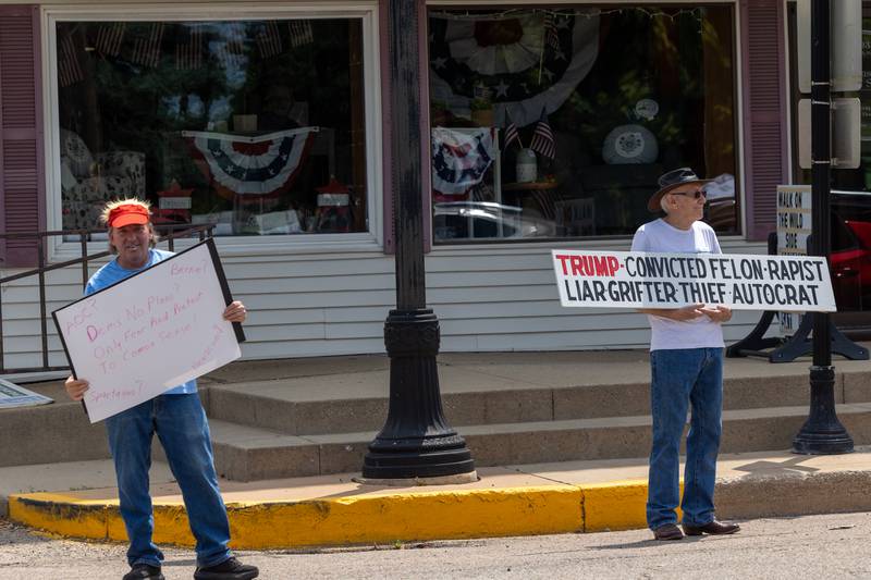 (left to right) Protester of the “No Kings” movement holds sign next to protester of the “No Kings” protest on north Main Street on Saturday, June 14, 2025 in Princeton.