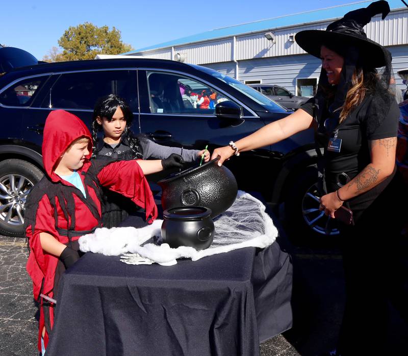 Leo Vilumis and Arianna Arroyo pick a treat at the Fox Valley Family YMCA West branch Trick or Trunk on Sunday, Oct. 26, 2025 in Sandwich.
.