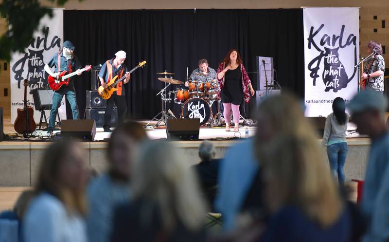 Local band Karla and the Phat Cats performs in teh bandstand in Memorial Park at the Cream of Wheaton summer festival in downtown Wheaton on Thursday, May 30, 2024.