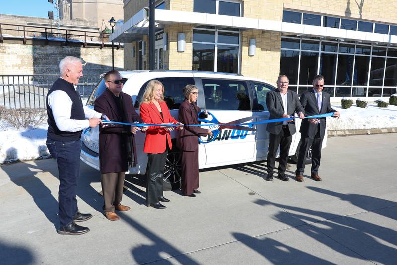 Elected officials and Pace members cut a ribbon at the official launch of the Pace VanGo vanpool reservation-based round-trip service on Thursday, Dec. 4, 2025 in Joliet.