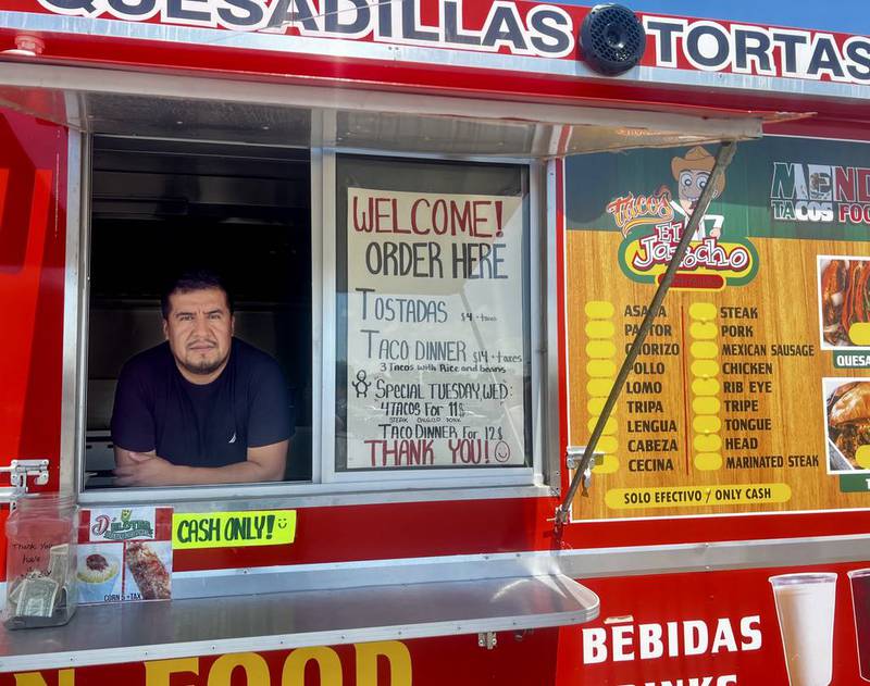 Owner Angel Mendoza stands ready to greet customers inside the Mendoza Tacos Food Truck at the corner of West 10th Street and First Avenue in Rock Falls, Illinois, on June 27, 2025.