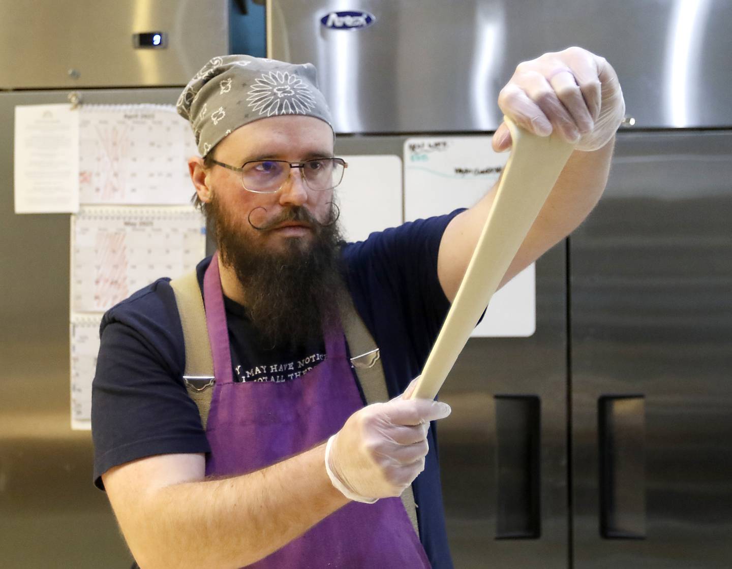Caleb Hill makes croissants on Friday, March 21, 2025, at Cheshire Cakes, in Crystal Lake.