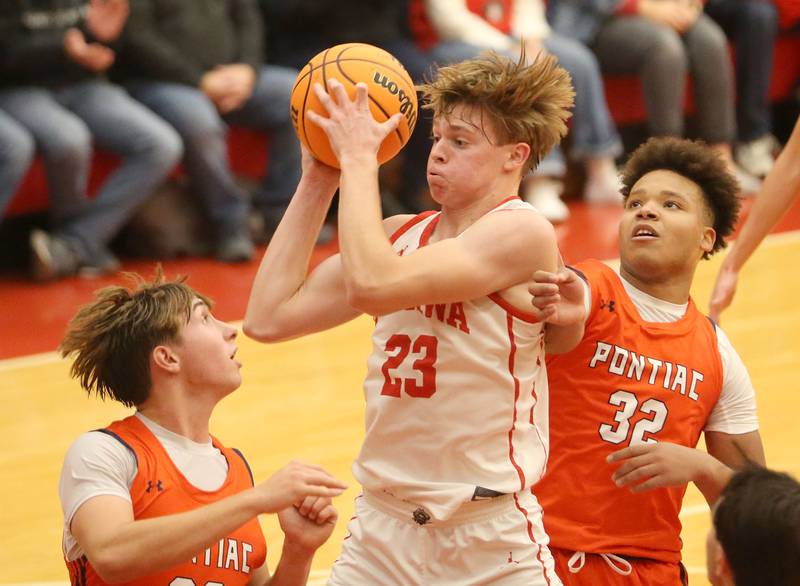 Ottawa's Owen Sanders grabs a rebound over Pontiac's Cayden Masching and teammate Riley Johnson during the Dean Riley Shootin' The Rock Thanksgiving Tournament on Monday, Nov. 25, 2024 in Kingman Gym at Ottawa High School.