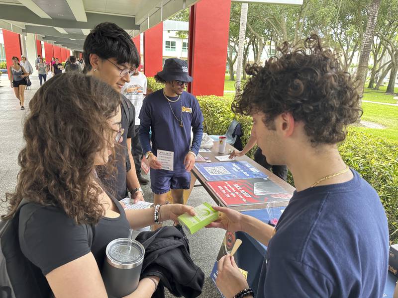 FILE - College students pass out Plan B to educate young voters at Florida Atlantic University April 11, 2024, in Boca Raton, Fla. (AP Photo/Cody Jackson, File)