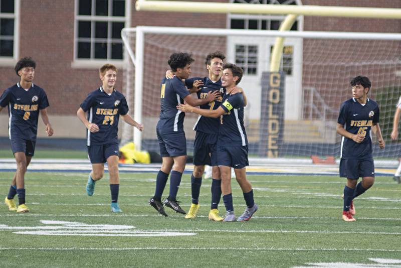 Sterling teammates celebrate Sterling Farbicio Pena’s goal against Genseso Tuesday, Sept. 20, 2022.