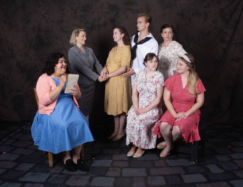 The cast of Elmhurst GreenMan Troupe's "The Cover of Life" (l-r) Kelly Belmont (back, standing), Ashley Ries, Maxwell Reise, Jennifer Fisher (front, seated), Natali Chavez, Carissa Lehning, Megan Conrad.
