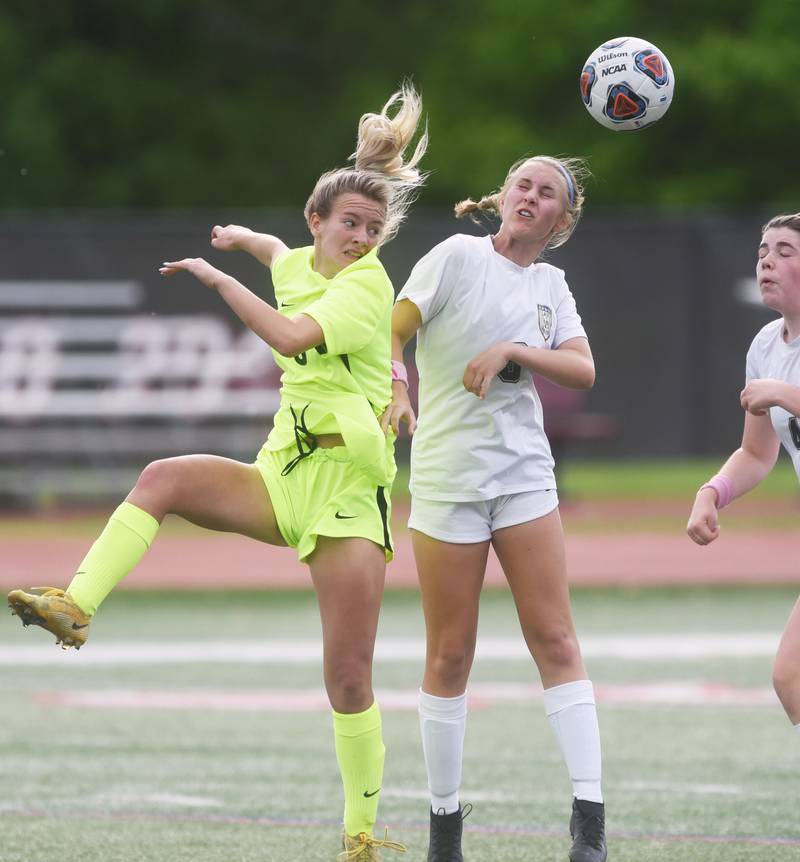 Richmond-Burton's Reese Frericks, left, and Quincy Notre Dame's Audrey Sparrow jump after the loose ball during Saturday’s IHSA Class 1A state girls soccer championship game at North Central College in Naperville.