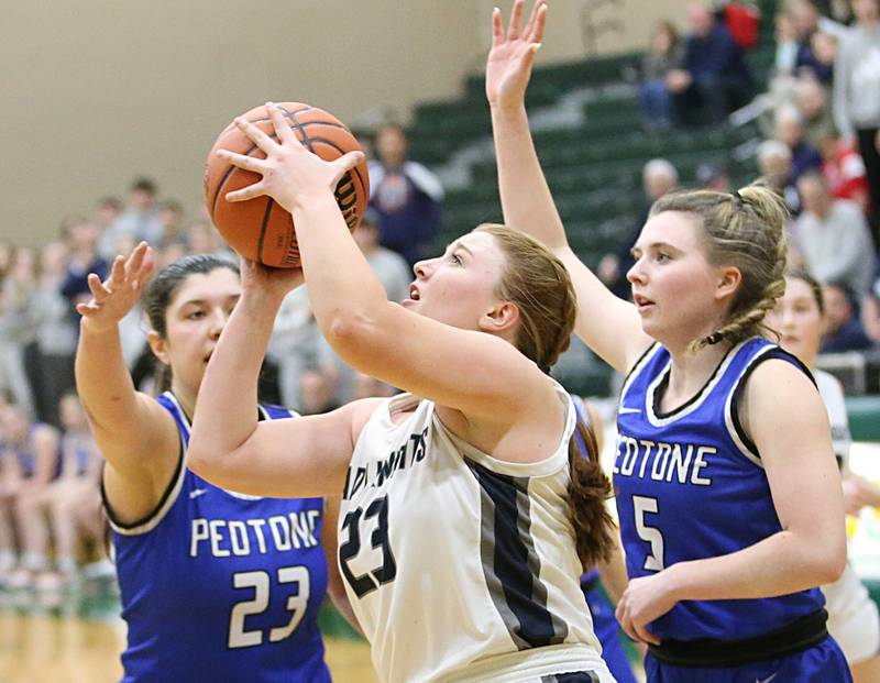 Fieldcrest's Riley Burton dribbles in the lane to shoot a shot over Peotone's Jenna Hunter and teammate Ashley Renwick during the Class 2A Sectional final on Thursday, Feb. 20, 2023 at Coal City High School.