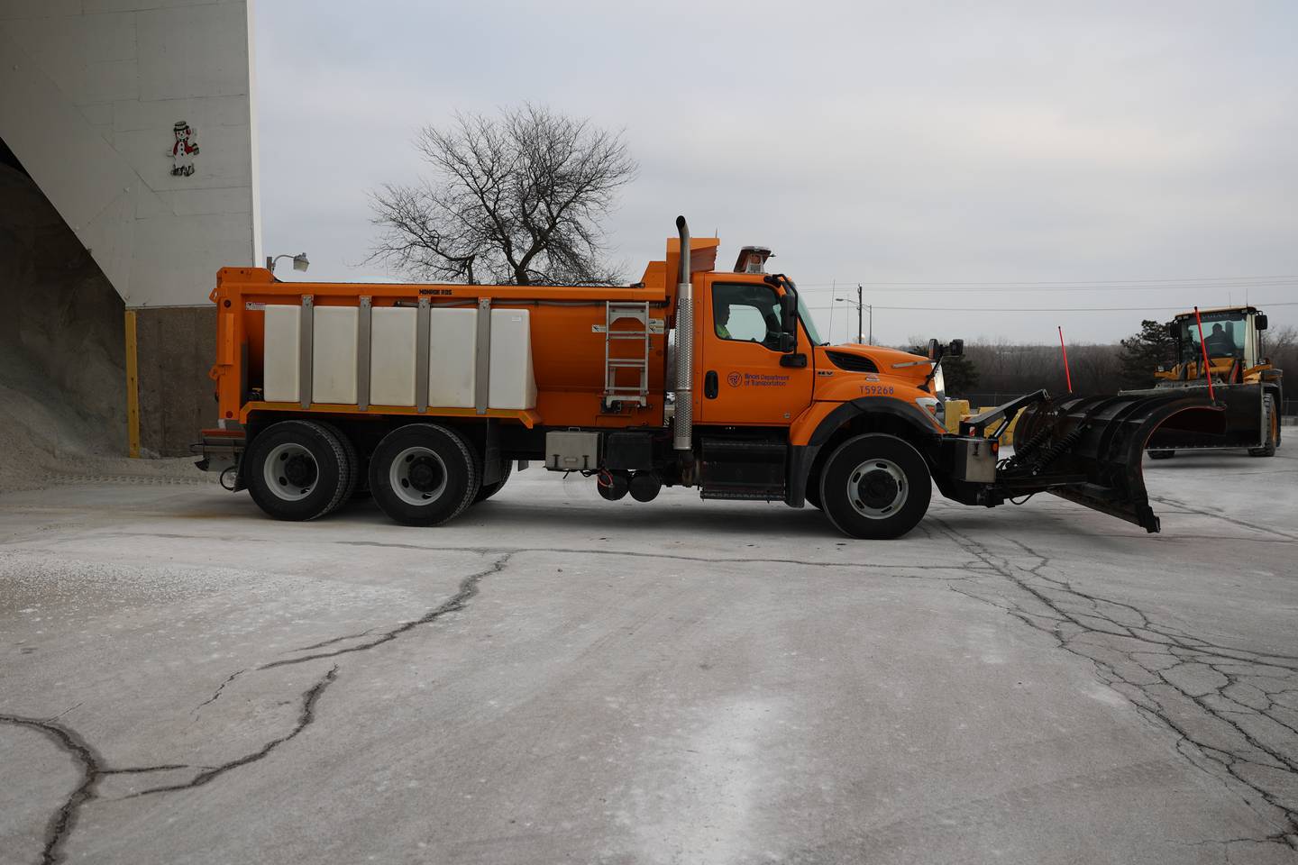 A truck backs up to a salt pile at the IDOT facility in Lockport.