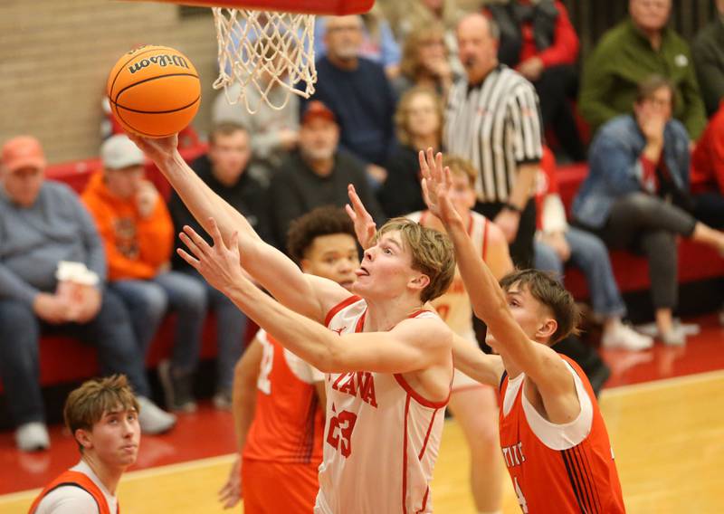 Ottawa's Owen Sanders runs in for a layup over Pontiac's Jermey Melton during the Dean Riley Shootin' The Rock Thanksgiving Tournament on Monday, Nov. 25, 2024 in Kingman Gym at Ottawa High School.