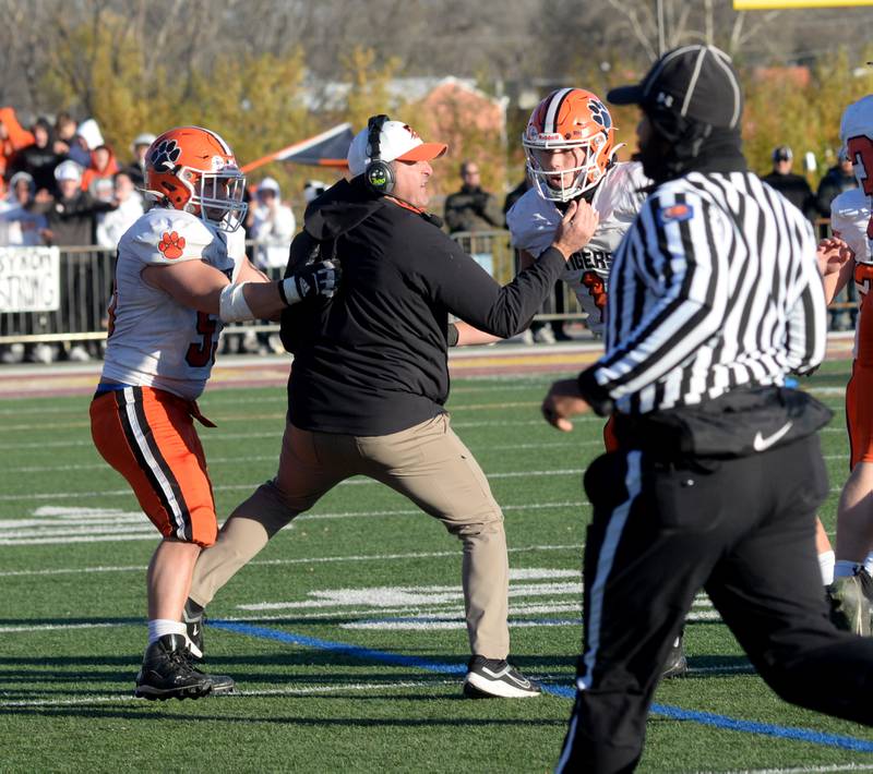 Byron assistant coach Sean Considine (center) directs the defense in the final seconds of the Tigers' win over Lombard-Montini  during 3A football semifinal in Lombard on Saturday, Nov. 18, 2023.