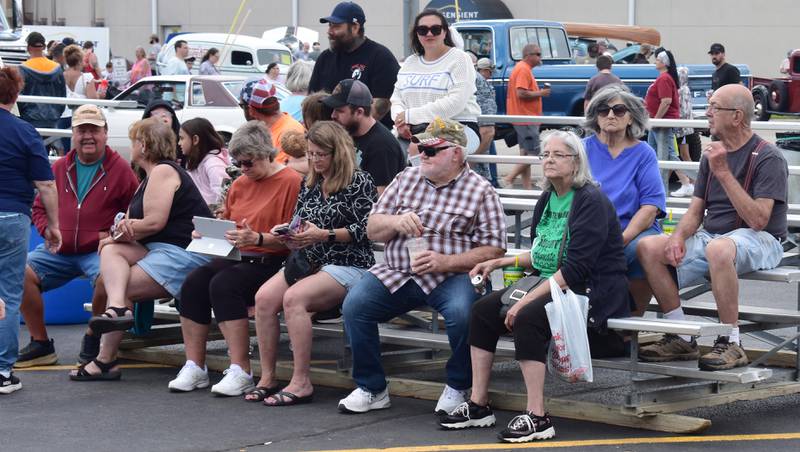 A crowd of people listen to the "Old Skool" band while attending the car show in Amboy on Sunday, Aug. 24, 2025.