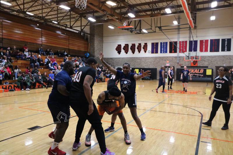 Xavier Johnson corals a rebound Monday, Dec. 2, 2024, at the annual charity basketball game held at Huntley Middle School in DeKalb.