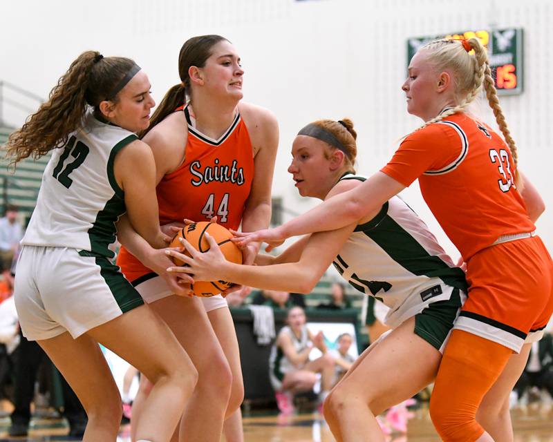 St. Charles East's Caleigh Higgins (44) and Glenbard West's Sophia Evans (24) battle for the ball while Glenbard West's Lily Pones (12) and St. Charles East's Addison Schilb (33) come in for assistance as a jump ball was called on Thursday Feb. 26, 2026, during the 4A Sectional championship game held at Bartlett High School.