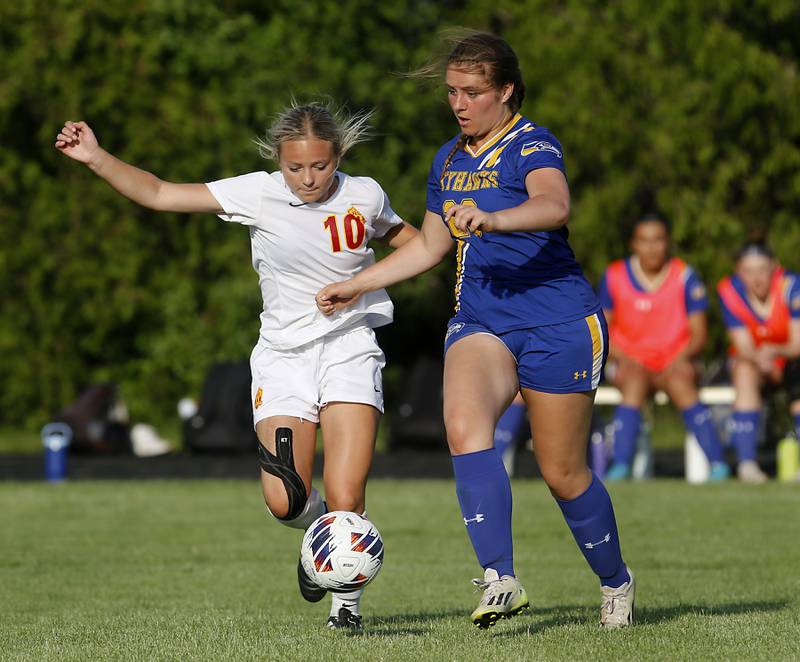 Richmond-Burton's Maddie Seyller kicks the ball away from Johnsburg's Kiara Welch during the IHSA Class 1A Marian Central Sectional Championship match on Tuesday, May 21, 2024, at Marian Central High School.