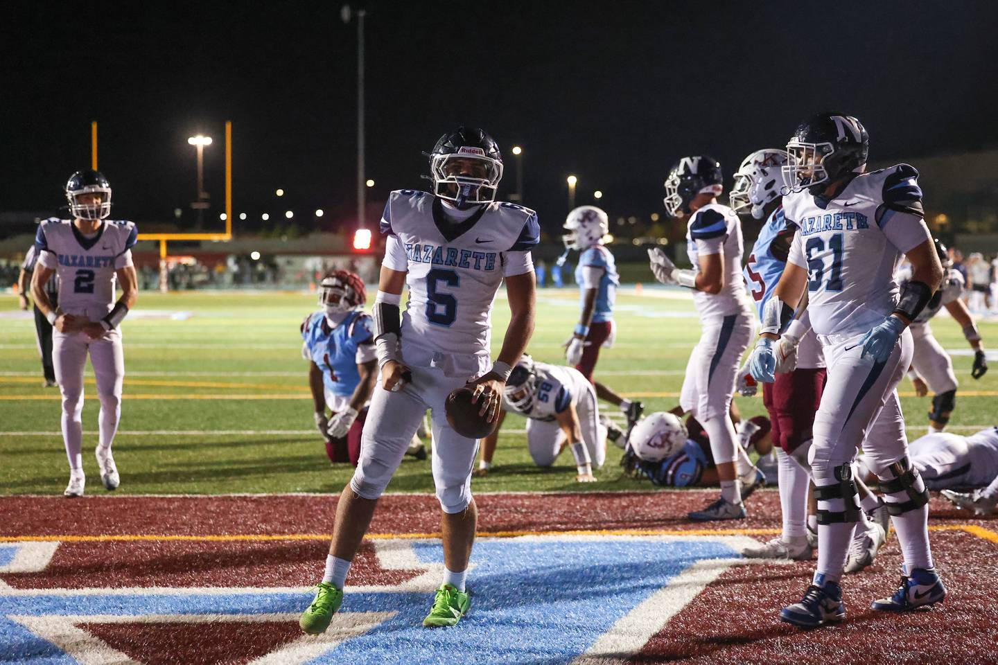 Nazareth's Dylan Wellner, center, celebrates a touchdown during Nazareth's 33-12 victory over Kankakee on Friday, Aug. 29, 2025.