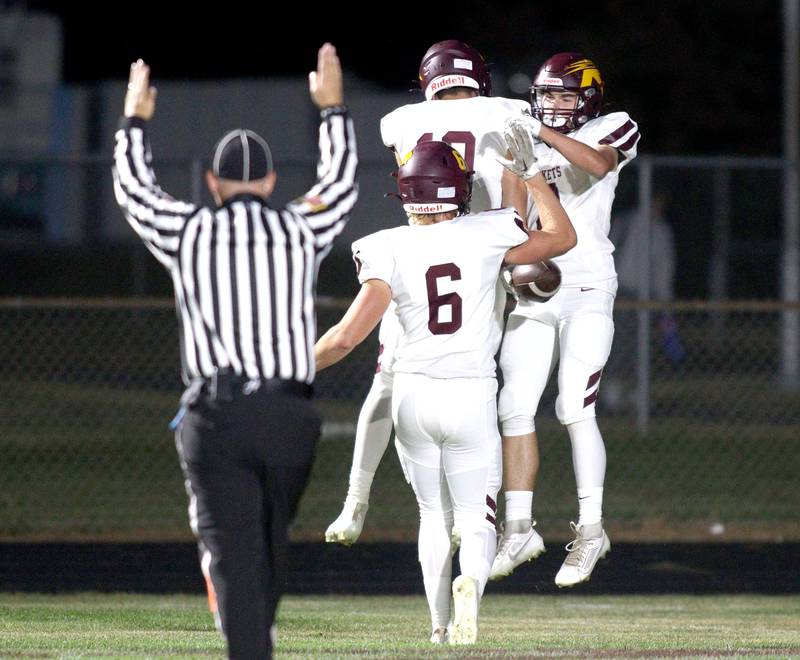 Richmond-Burton’s Rockets celebrate a Jack Martens first-half touchdown in varsity football at Rod Poppe Field in Marengo Thursday night.