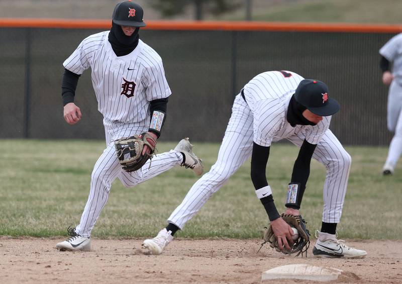 DeKalb's Jackson Kees fields a grounder in front of Nikolas Nelson during their game against Harlem Tuesday, April 1, 2025, at DeKalb High School.