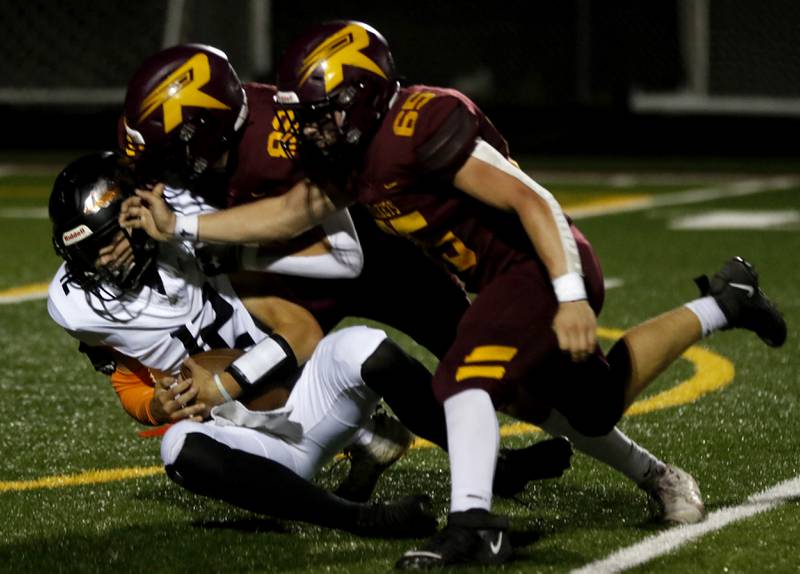 Richmond-Burton's Luke Robinson sacks Sandwich's Braden Behringer during a Kishwaukee River Conference football game on Friday, Oct. 4, 2024, at Richmond-Burton High School.