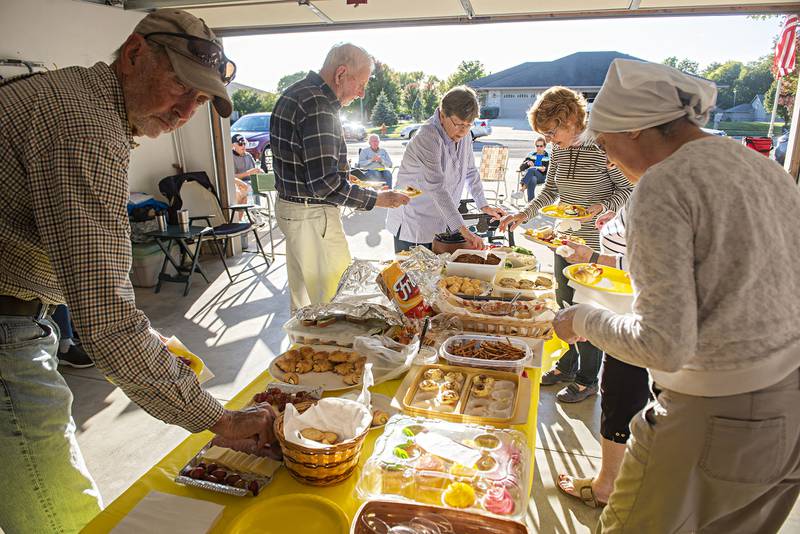 The table in Don Trent's garage is laid out with savory and sweet snacks. But the real draw is the coming together of the community. Of the 31 residents in the cul-de-sac, they regularly bring in 27-28 revelers.