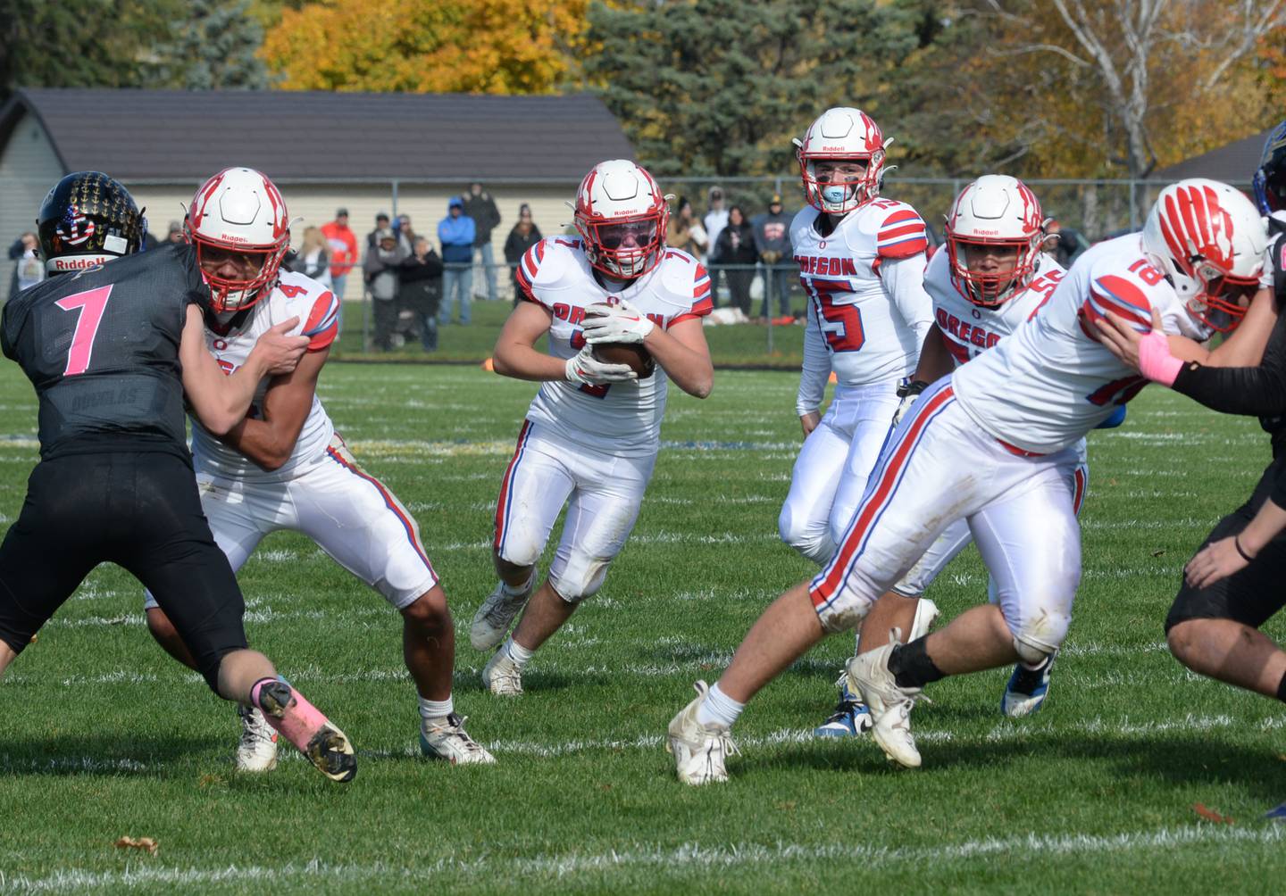 Oregon's Logan Weems (7) runs with the ball as Quentin Berry (4) and Josh Crandall (18)  block during 3A playoff action against Durand-Pecatonica on Saturday, Oct. 28, 2023 at Pecatonica High School.