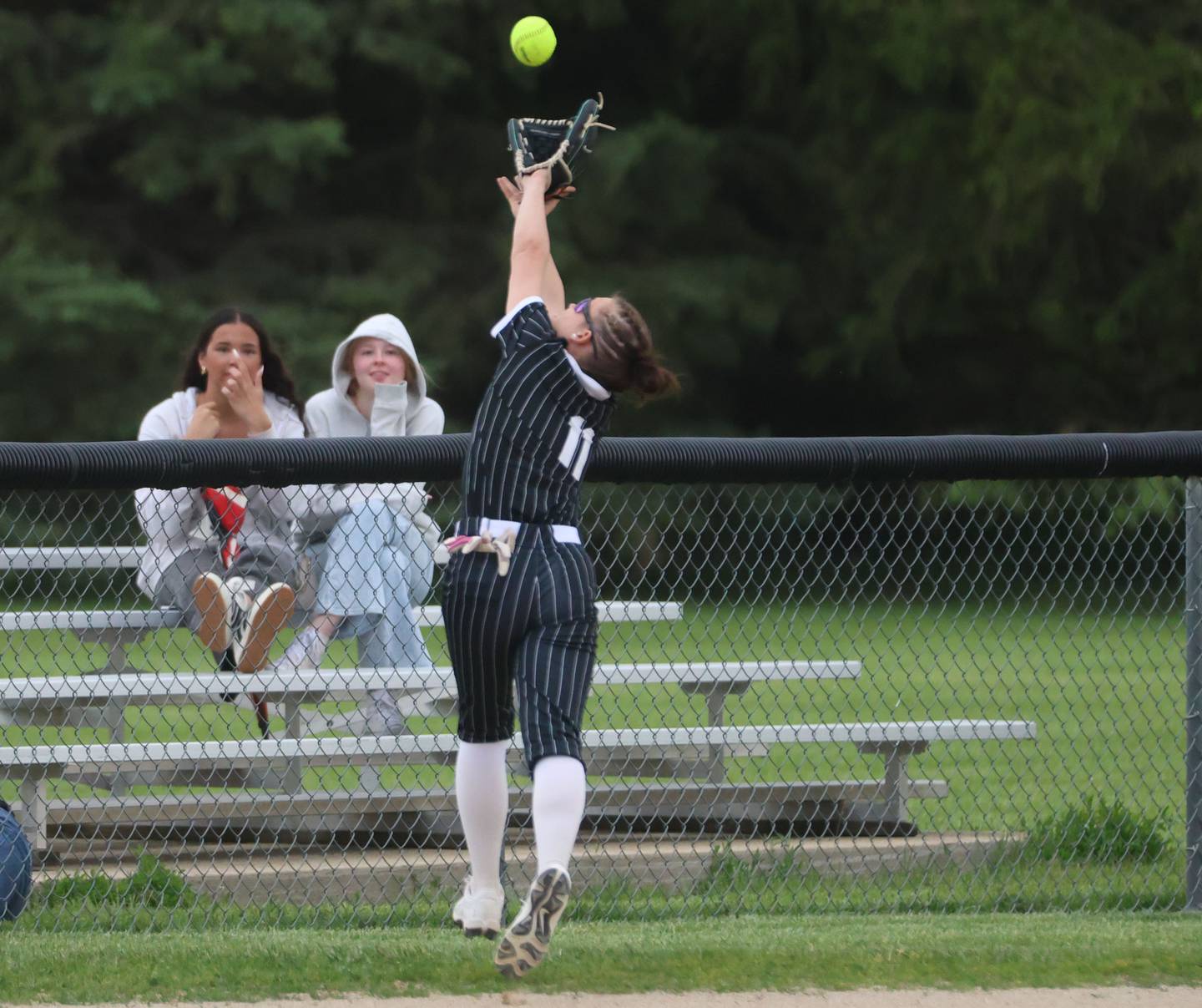 Woodland's Bristol Flowers makes a running catch in foul territory on Tuesday, May 12, 2026 at Woodland High School.