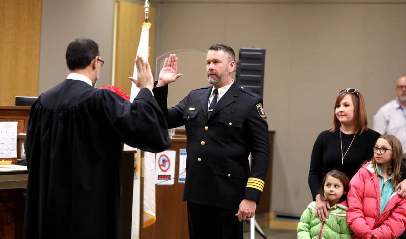 Kane County Sheriff Ron Hain is sworn in by Judge Rene Cruz as his wife Ashley and two of their children, Sloane (right), 10, and Delavan, 6, look on at the Kane County Circuit Court in St. Charles on Monday, Dec. 5, 2022.
