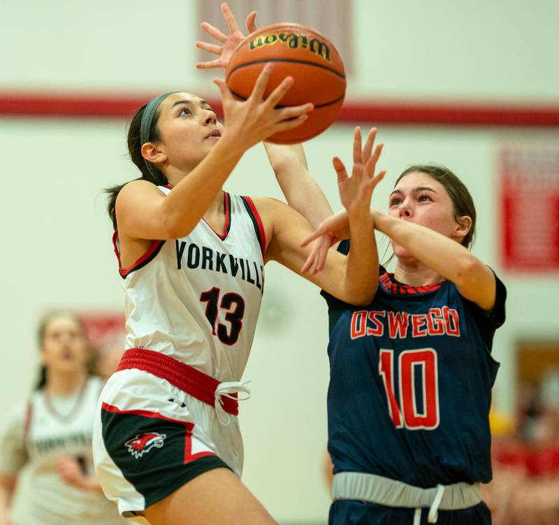 Yorkville's Kaelie Moreno (13) shoots the ball in the post against Oswego’s Maggie Voller (10) during the 13th annual Hoops 4 Hope Communities vs. Cancer basketball event at Yorkville High School on Saturday, Jan 28, 2023.