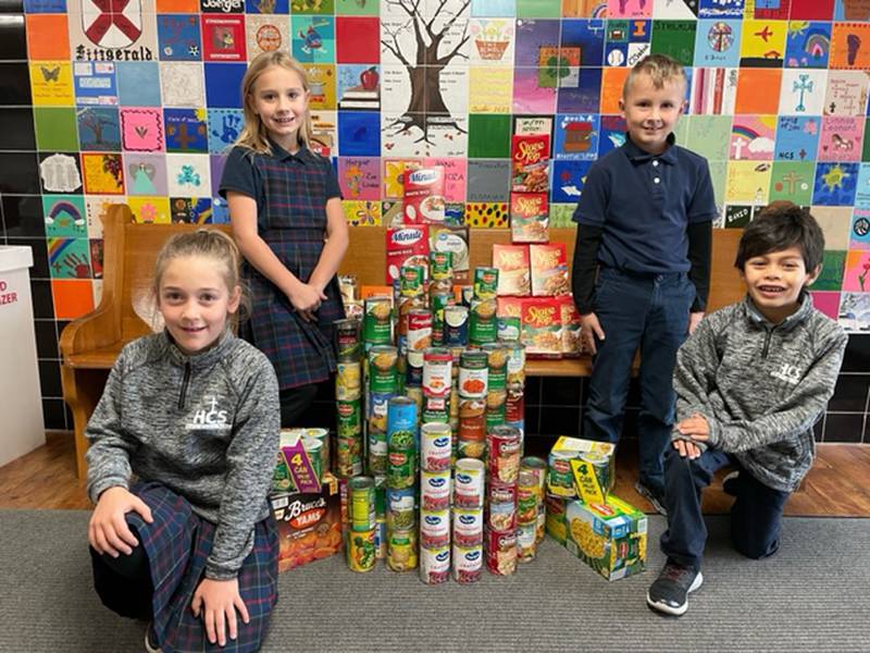Holy Cross School in Mendota collected dry goods and canned goods for the Mendota Area Christian Food Pantry, collecting 242 pounds to help those in need." Pictured from left are McKenna Faber, Candice Boysen, Kyle Henkel and Adan Delao.
