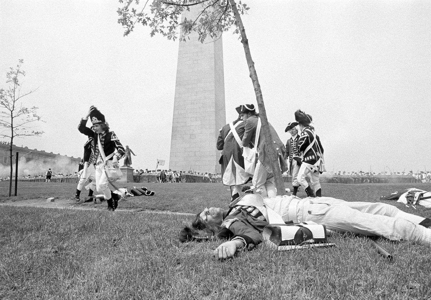 British soldiers fall and retreat from the first of three attacks in the re-enactment of the Battle of Bunker Hill in Boston's Charlestown section on June 14, 1975. Bunker Hill Monument is in the background.