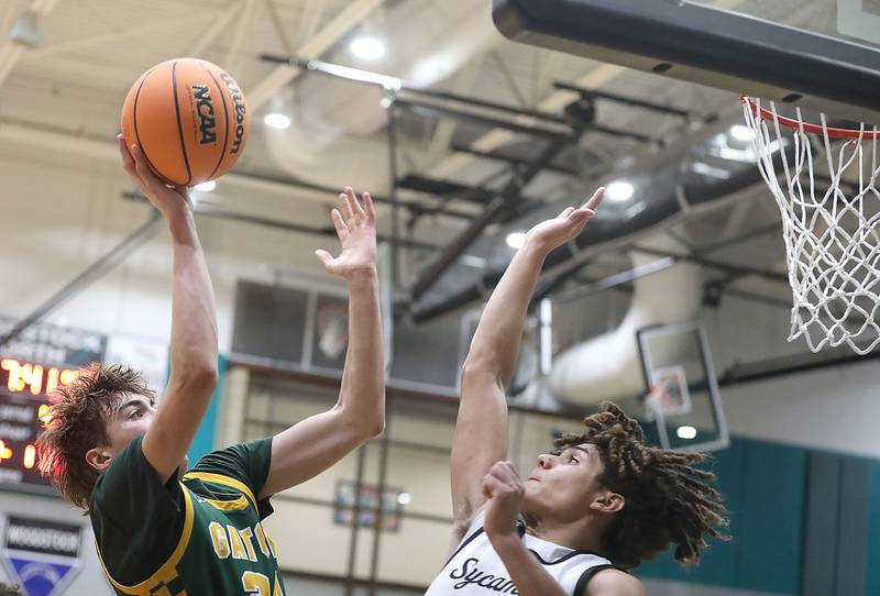 Crystal Lake South's Vincent Santarelli shoots the ball over Sycamore's Josiah Mitchell during an IHSA Class 3A Woodstock North Sectional semifinal.basketball game on Wednesday, March 4, 2025, at Woodstock North High School.