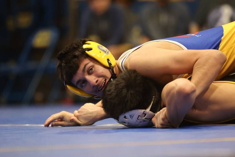 Joliet Central’s Aleck Allende works over Joliet West’s Joseph Pedrosa in the 120-pound weight match at Joliet Central on Friday, Jan 31, 2025.