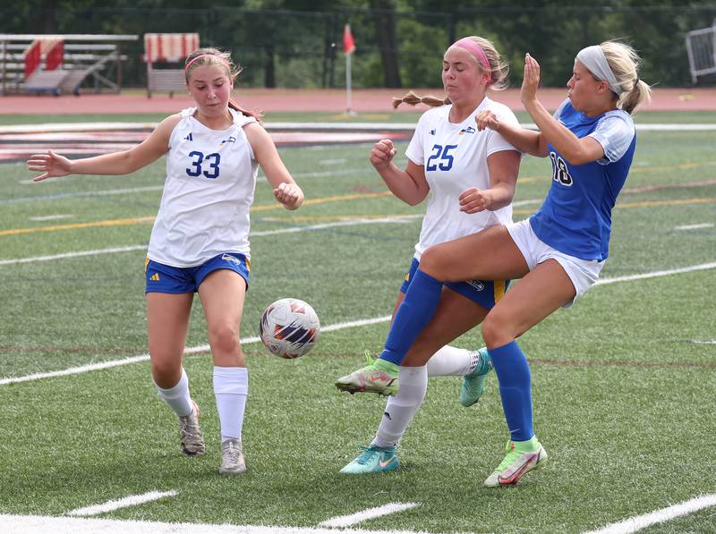 Johnsburg's Gabriella Kay (left) and Jacquelyn Douglas arrive at the ball at the same time as Columbia's Kate Adams Saturday, June 7, 2025, during the IHSA Class 1A state championship game at North Central College in Naperville.