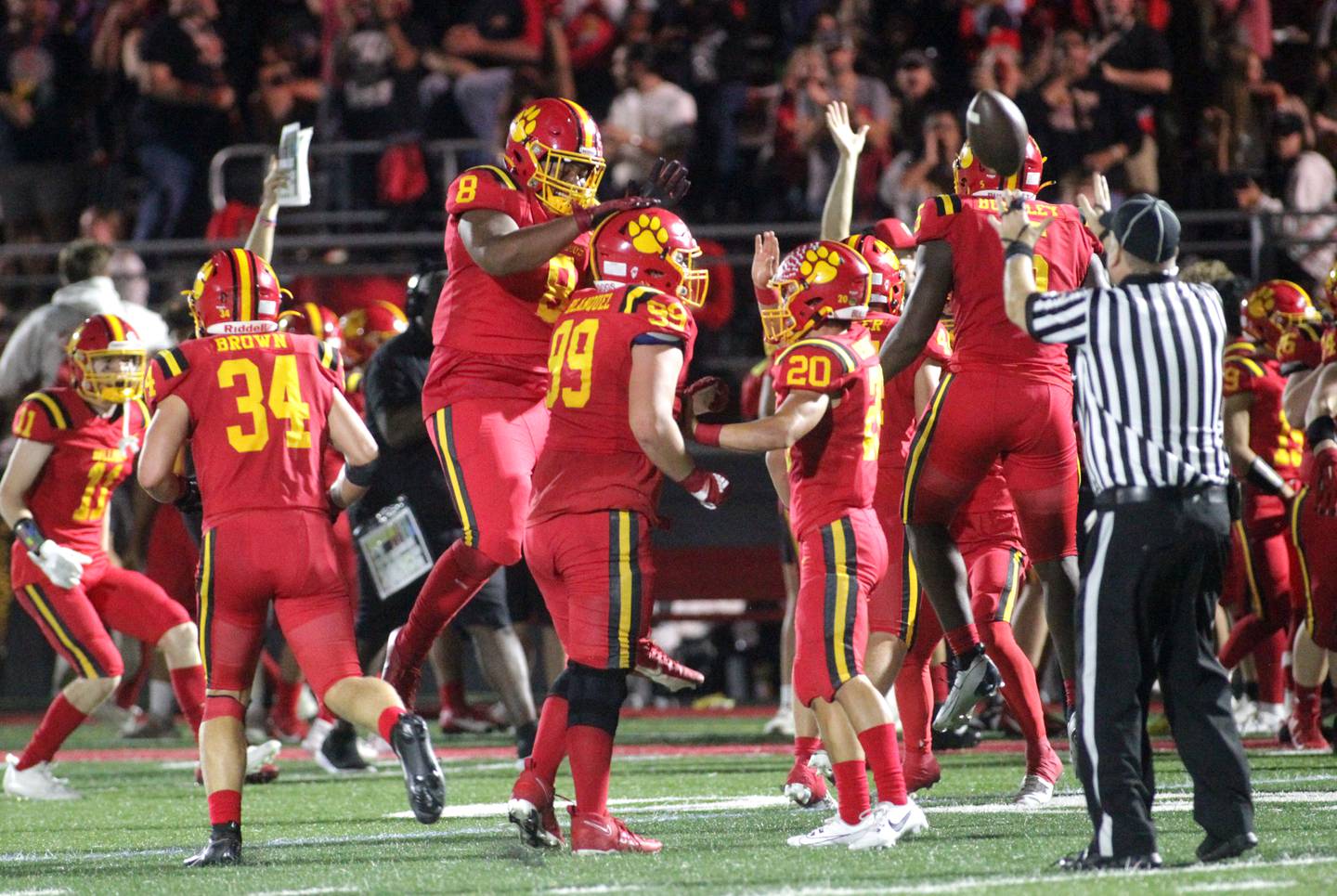 Batavia’s defense celebrate a turnover by teammate Xavier Blanquel (center) during a home game against Wheaton North on Friday, Sept. 22, 2023.