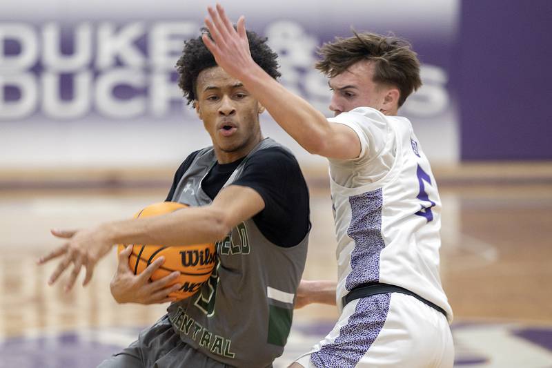 Plainfield Central’s Zion Finch drives to the hoop against Dixon’s Brady Feit Friday, Jan. 3, 2025, at Dixon High School.