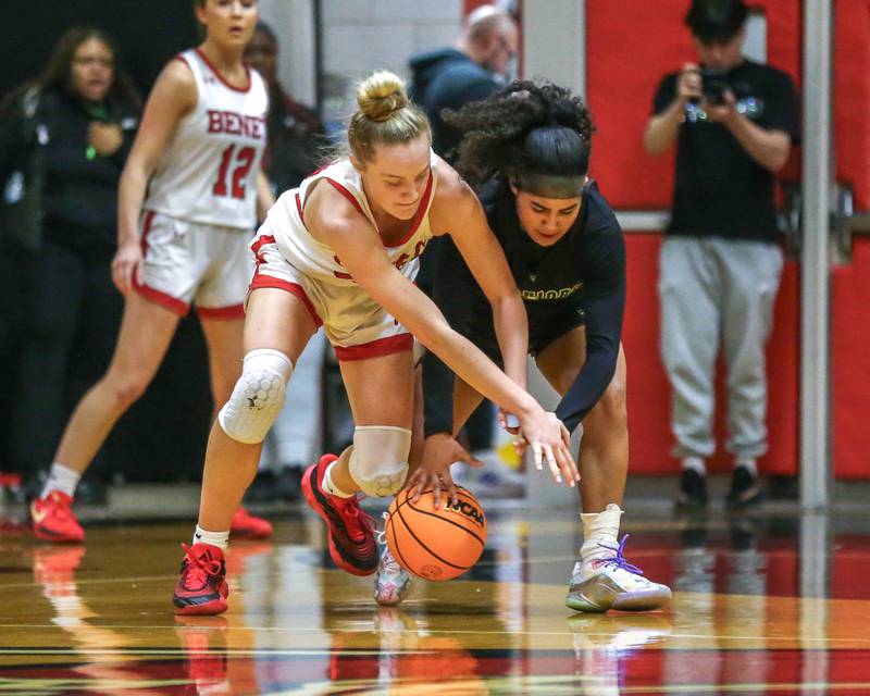 Benet's Bridget Rifenburg (22) fights off Waubonsie Valley's Arianna Garcia (1) for possession during their Class 4A Bolingbrook Sectional final basketball game between Waubonsie Valley at Benet. Feb 27, 2025 in Bolingbrook.