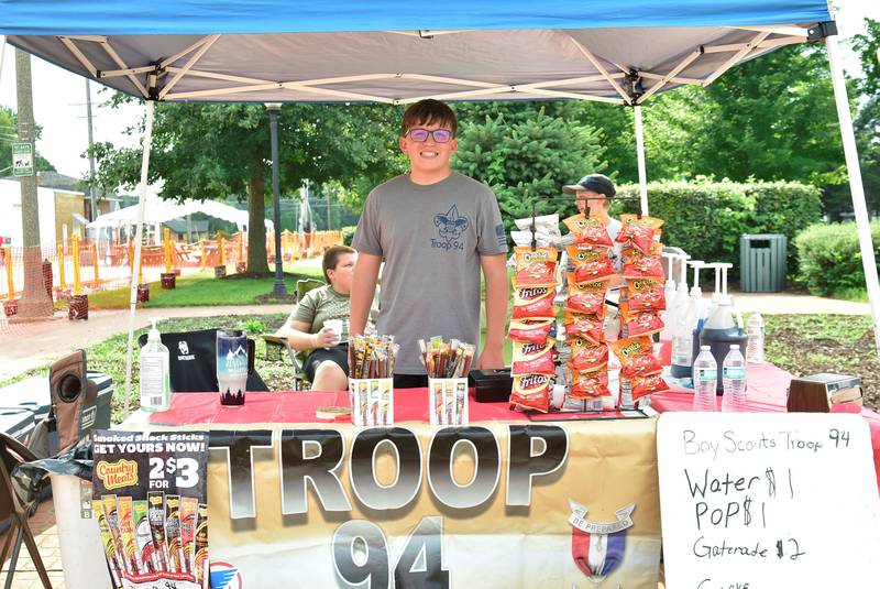 13-year-old Owen White with Prophetstown Boy Scout Troop 94, works hard selling drinks and snacks Saturday, August 9, 2025 at Eclipse Square in Prophetstown during the Make a Farmer festival.