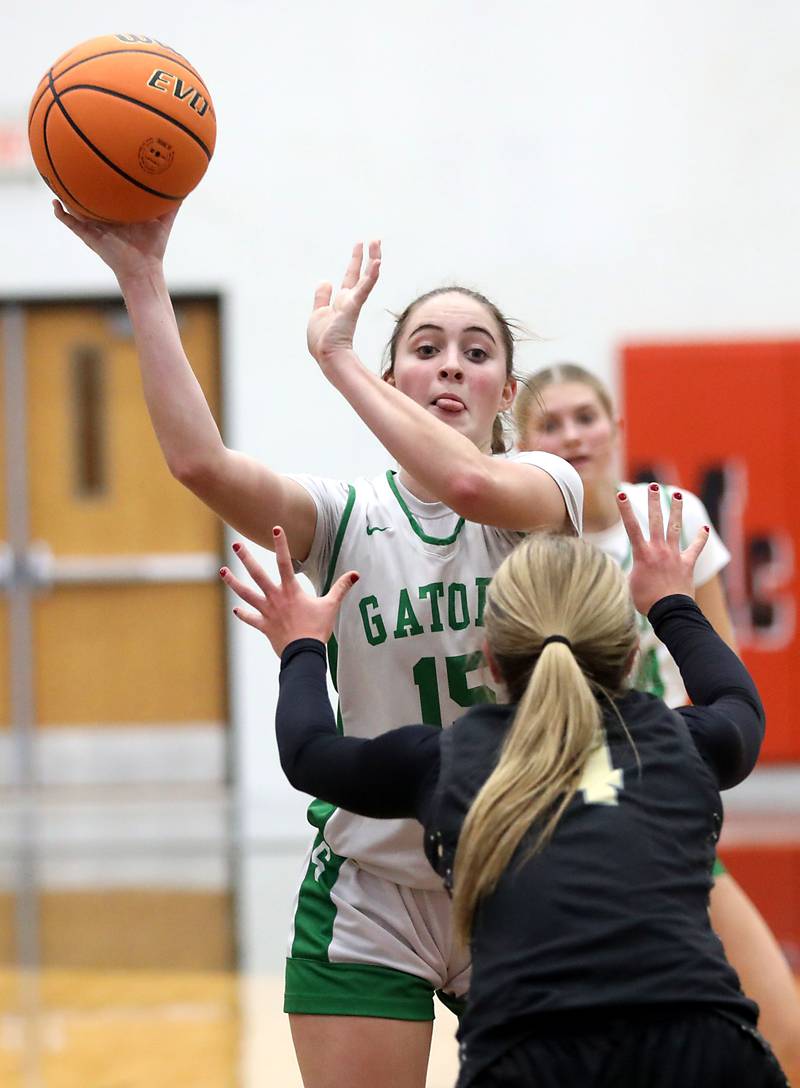 Crystal Lake South's Tessa Melhuish passes the ball as she is defended by Grayslake North's Lucy Roscoe during a Northern Illinois Holiday Classic semifinal girl basketball game on Tuesday, Dec. 16, 2025, at McHenry High School.