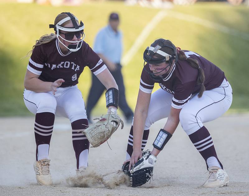 Dakota’s Jersie Banks (left) and AJ Howarth work to field a bunt against Milledgeville Tuesday, May 26, 2026, at the Eastland Class 1A softball sectional quarterfinal.