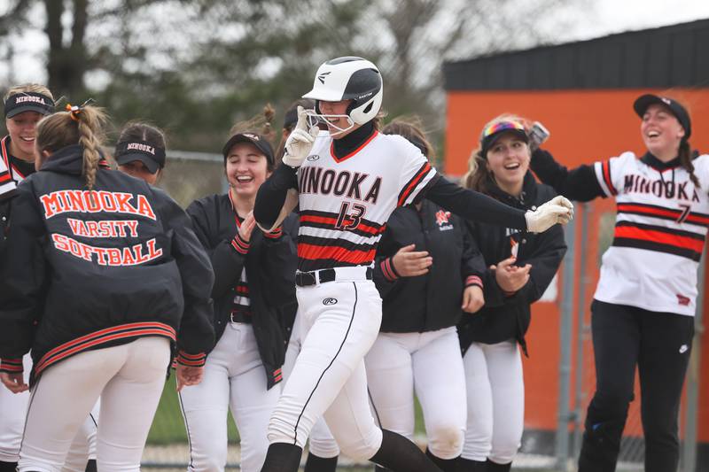 Minooka’s Gracie Anderson is greeted at home plate following her solo home run against Oswego on Wednesday, April 17, 2024 in Minooka.