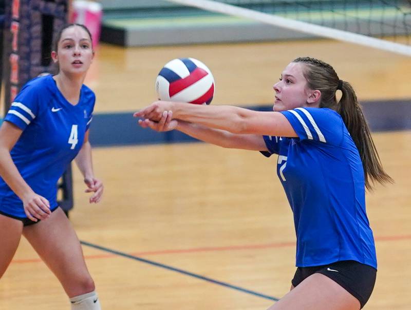 Rosary’s Molly Lambert (7) bump sets the ball against Oswego during a volleyball match at Oswego High School on Tuesday, Aug 29, 2023.