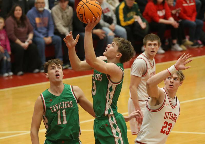 L-P's Braylin Bond gets in the lane to score on a layup past Ottawa's Owen Sanders on Friday, Feb. 6, 2026 in Kingman Gymnasium at Ottawa High School.