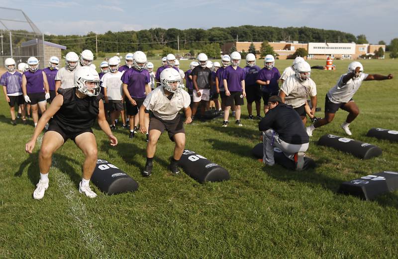 Hampshire football players run a blocking drill during the first day of football practice Monday, August 7, 2023, at Hampshire High School.