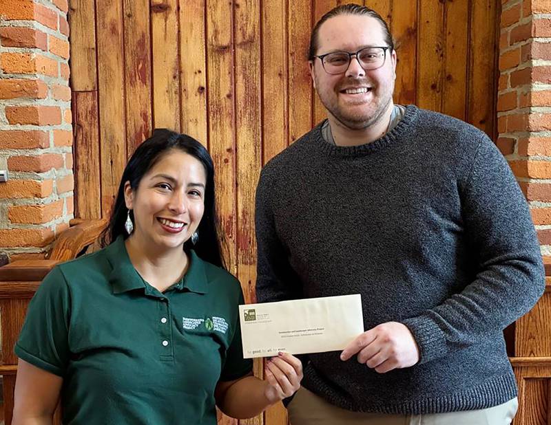 Farmworker and Landscaper Advocacy Project bilingual manager of programs Claudia Oliveros (left) accepting a 2025 Promise Grant from DeKalb County Community Foundation grants manager Austin Schroeder