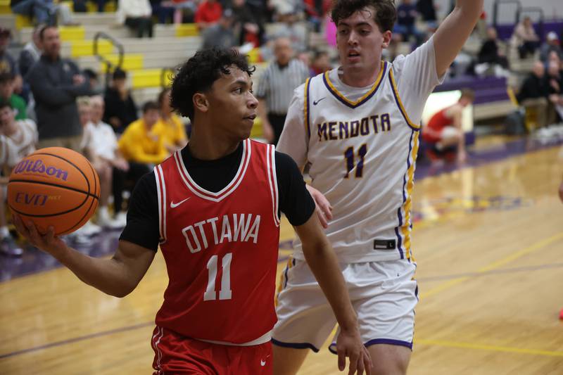 Ottawa's Hezekiah Joachim looks to pass the ball off around Mendota's Aden Tillman on Tuesday, Jan. 6, 2026 at Mendota High School.