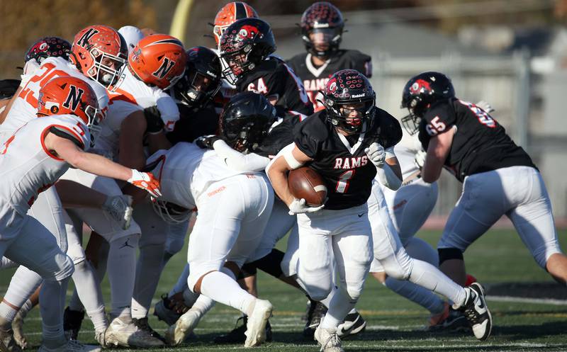 Glenbard East's Matthew Larson (1) looks for running room during the IHSA Class 7A quarterfinals Saturday November 11, 2023 in Lombard.