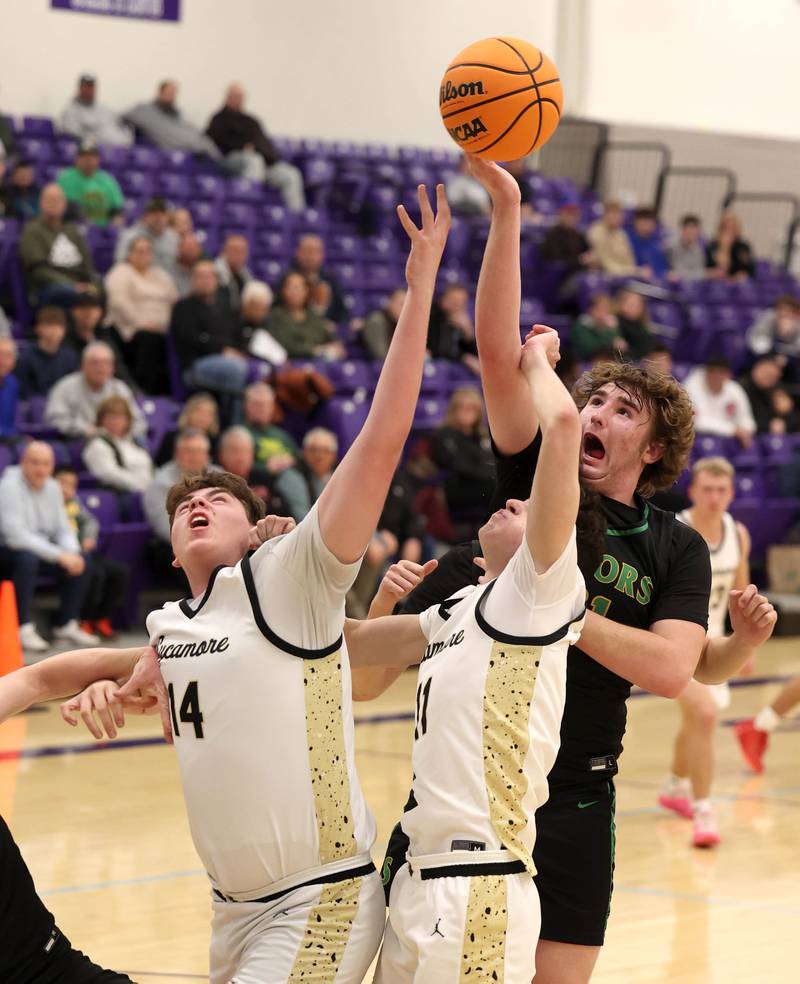 Crystal Lake South's Ryan Morgan tries to grab a rebound between Sycamore's Michael Chami (left) and Jake Shipley during their sectional semifinal game Tuesday, March 4, 2025, at Rochelle High School.