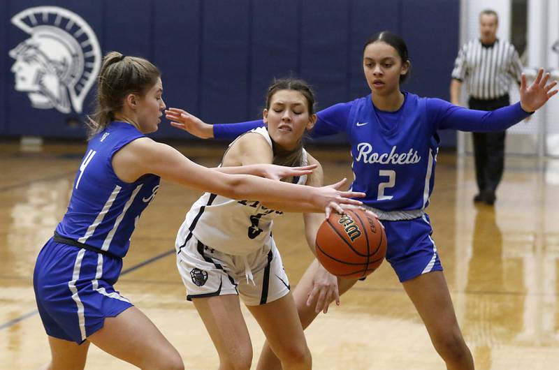 Cary-Grove's Aubrey Lonergan tries to pass out of the double-team of Burlington Central's Emersyn Fry, and Jordyn Charles during a Fox Valley Conference girls basketball game Friday Jan. 6, 2023, at Cary-Grove High School in Cary.