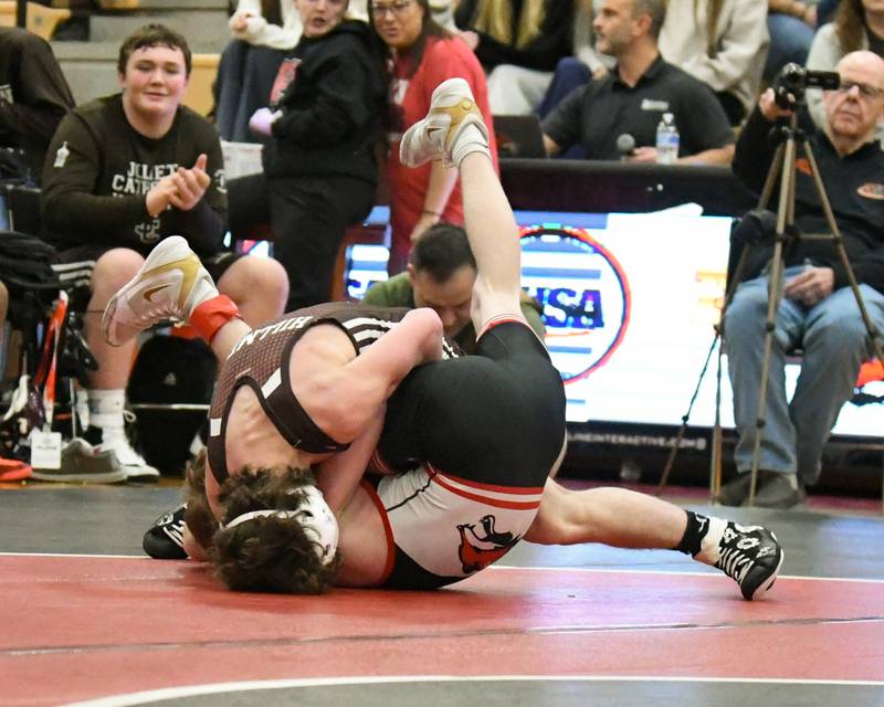 Lukas Foster of Joliet Catholic Academy, left, pins Landon Jekins of Yorkville in the 113-weight class during the regional meet on Tuesday Feb. 25, 2025, held at Yorkville High School.