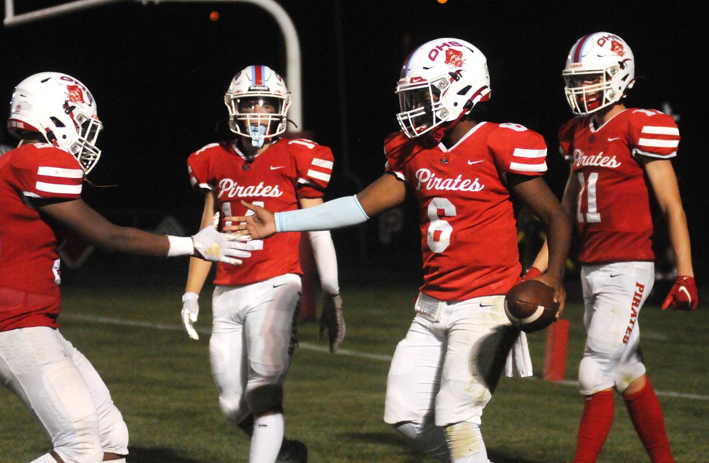 Ottawa quarterback Colby Mortenson celebrates with teammates after running in a touchdown against Streator at King Field on Friday, Sept. 1, 2023.